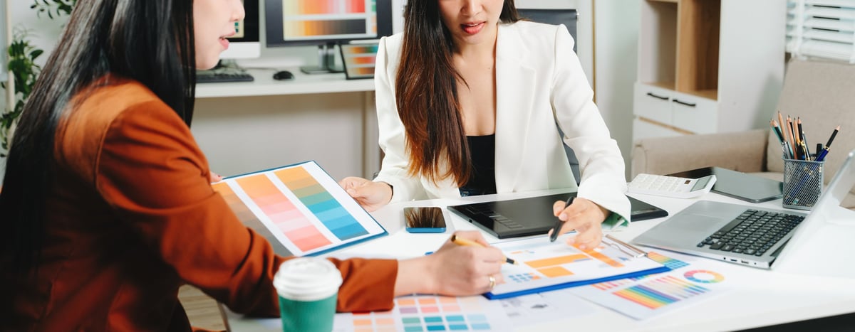Business owners and a designer planning a website together